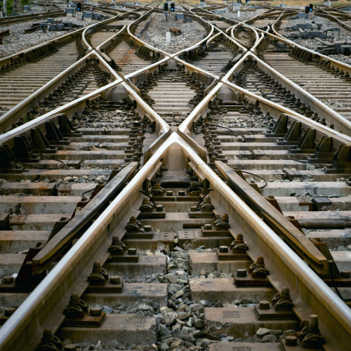 Four sets of train tracks, two of which cross over each other